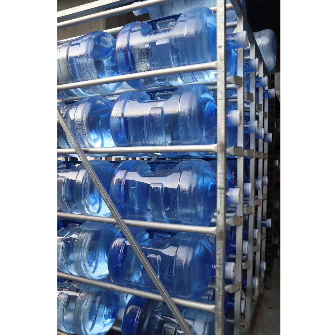 Large blue water jugs stacked on metal racks for delivery service in Southwest Louisiana