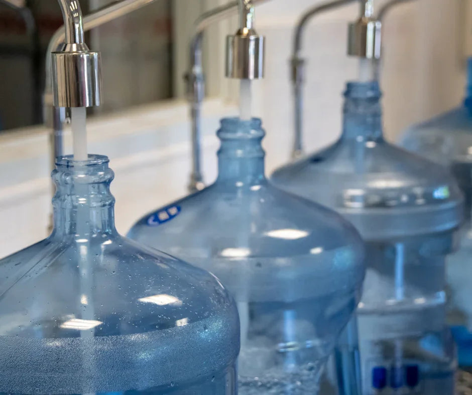 Large water jugs being filled at a water delivery service station in Southwest Louisiana